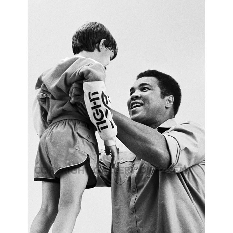 Ali Holding Up Child